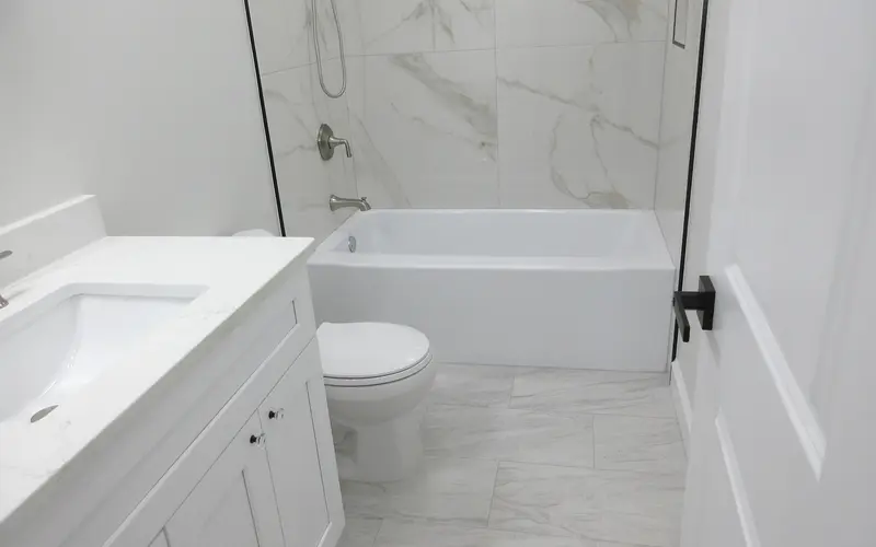 Guest-ready white bathroom with a clear glass shower screen